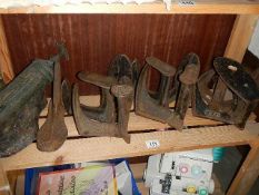 A quantity of cast iron cobblers boots lasts