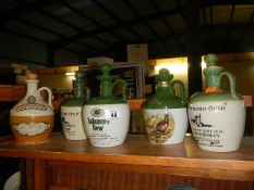 4 stoneware advertising breweriana whisky flagons and 1 other (all empty)