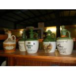 4 stoneware advertising breweriana whisky flagons and 1 other (all empty)