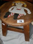 A carved wooden child's stool