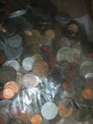 A kiloware bag of mixed UK and foreign coins