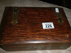 A vintage wooden box with ornate brass hinges and contents of costume jewellery