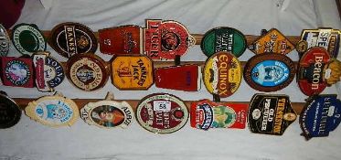 A good lot of breweriana pub beer clips on 3 wooden poles Collect only