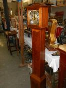 A walnut veneered with mahogany crossbanding Grandmother long case clock