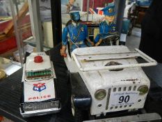 A Japanese tinplate battery operated police jeep by 'TN' A/F and a fiction police car
