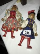 A pair of vintage Gromada wooden folk dolls in traditional clothes