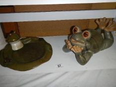 A large pottery frog and a frog on a lily pad