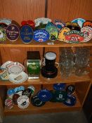 3 shelves of breweriana including pump clips, ashtrays, glasses,