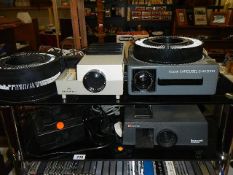 A Kodak slide projector and three others.