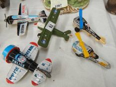 A quantity of tinplate helicopters and planes