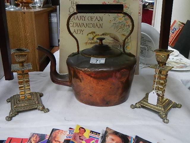 A Victorian copper kettle and pair of brass candlesticks