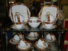 A vintage 12 setting standard china tea set with gold coloured detail (missing 1 cup)