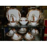 A vintage 12 setting standard china tea set with gold coloured detail (missing 1 cup)