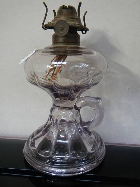 An unusual purple tinted glass finger oil lamp,