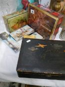 A quantity of old tins and a lacquered box,