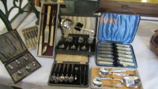 A quantity of cased cutlery sets.