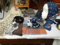 A mixed lot of headscarves, hats, scarves,