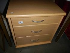 A modern three drawer bedroom chest.