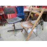 A metal framed folding chair and a typist's chair.