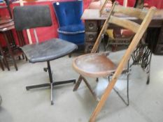A metal framed folding chair and a typist's chair.