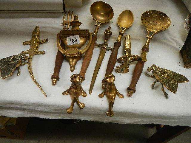 A mixed lot of brass door knockers and other brass ware.