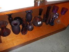 A large quantity of vintage purple art glassware including vases