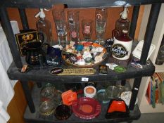 2 shelves of breweriana including ashtrays, bottle stoppers, jugs,