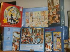 A quantity of jigsaw puzzles including cat related and two cat mugs.