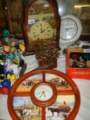 Two wall clocks, a cuckoo clock and a mantel clock.