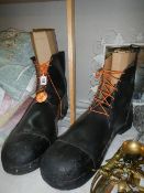 A pair of oversized (possibly for a clown) boots.