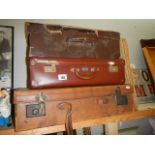 Three vintage suitcases.