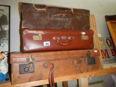 Three vintage suitcases.