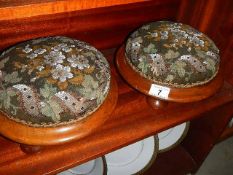 A pair of Victorian mahogany based foot stools with beaded tapestry covers