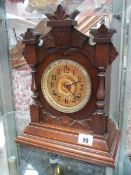 An early 20c mahogany mantle clock with gilded brass face by the Ansonia clock co New York,