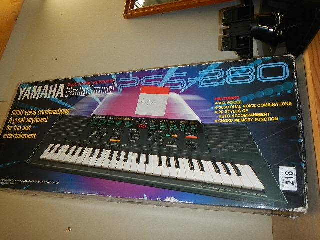 A boxed Yamaha Portasound key board, missing lead,