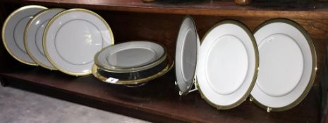 8 gold rimmed dinner plates and a glass cake stand