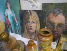 Three unframed oil portraits.