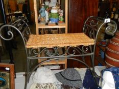 A modern wrought iron stool with wicker seat,