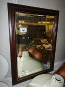 A BHS mahogany framed bevel edged mirror.
