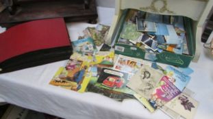 A mixed lot of postcards and an album of postcards including shipping, humorous etc.