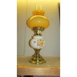 A ceramic and glass oil lamp with brass effect base,