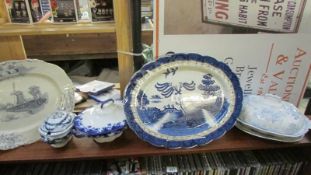 A large blue and white willow pattern meat platter, tureens etc.