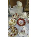 A mixed lot of bone china floral patterned cups and saucers.