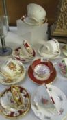 A mixed lot of bone china floral patterned cups and saucers.