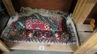 Two prayer mats and a rug.