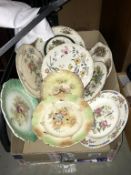 A box of antique and vintage plates.