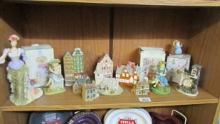 A mixed lot of ornaments including buildings, figures, small clock, (some in boxes).