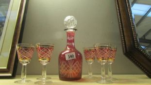 A cut glass overlaid ruby decanter and 6 glasses