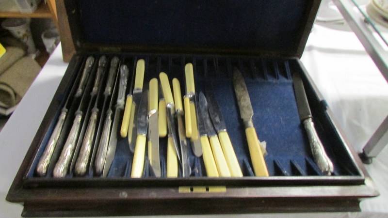 A Victorian Walnut cutlery case with a quantity of cutlery
