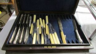 A Victorian Walnut cutlery case with a quantity of cutlery